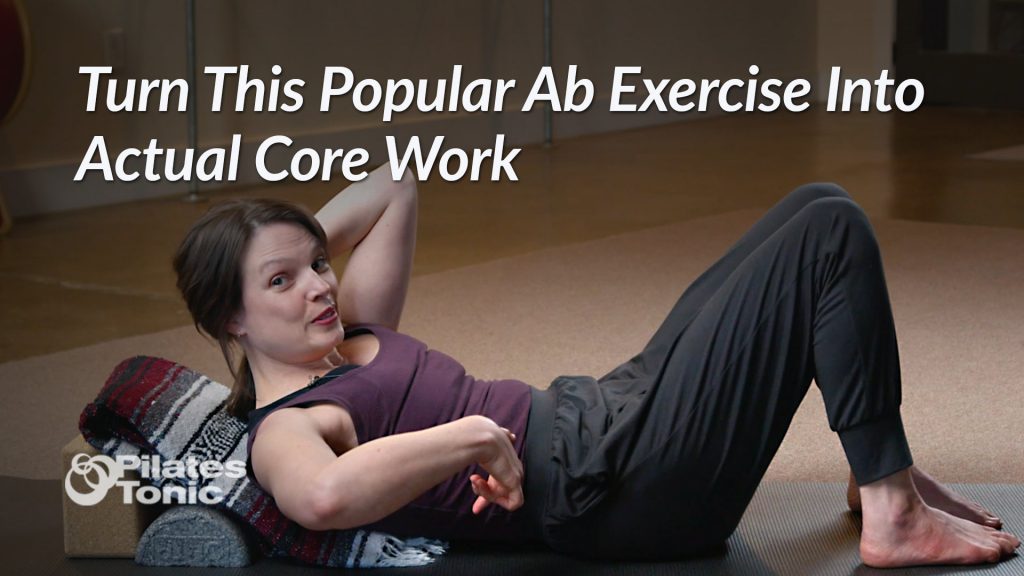 Photo - woman on mat in sit-up posture smiling