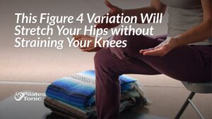 Person demonstrating modified figure 4 hip stretch while seated on folding chair