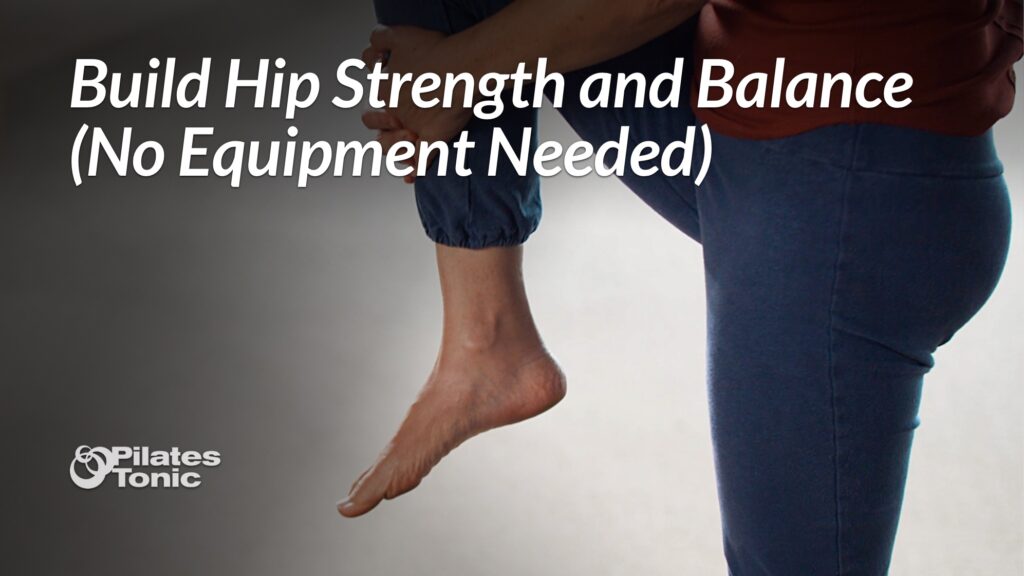 Woman standing on one leg while holding her opposite foot, demonstrating a balance exercise. Text overlay reads "Build Hip Strength and Balance (No Equipment Needed)" with the Pilates Tonic logo in the corner.